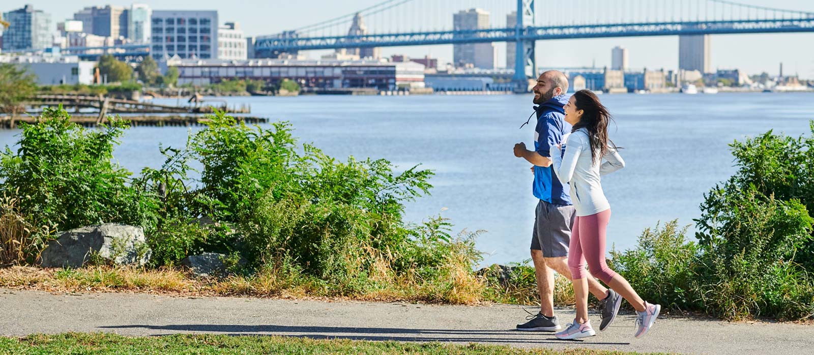 Couple jogging along Delaware River